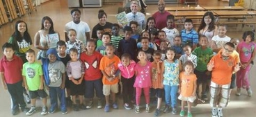 R.T. Ryback with students and staff from Harambee Elementary School